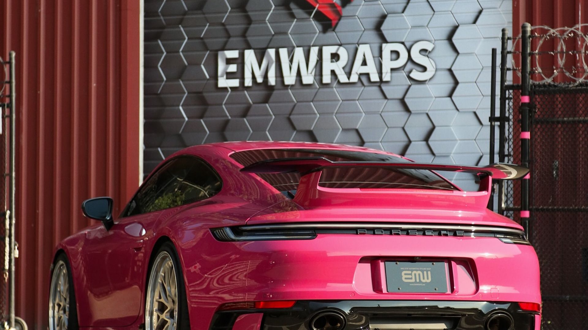 Ruby Star Neo Porsche 911 GT3 with full body PPF in front of the EMWRAPS shop