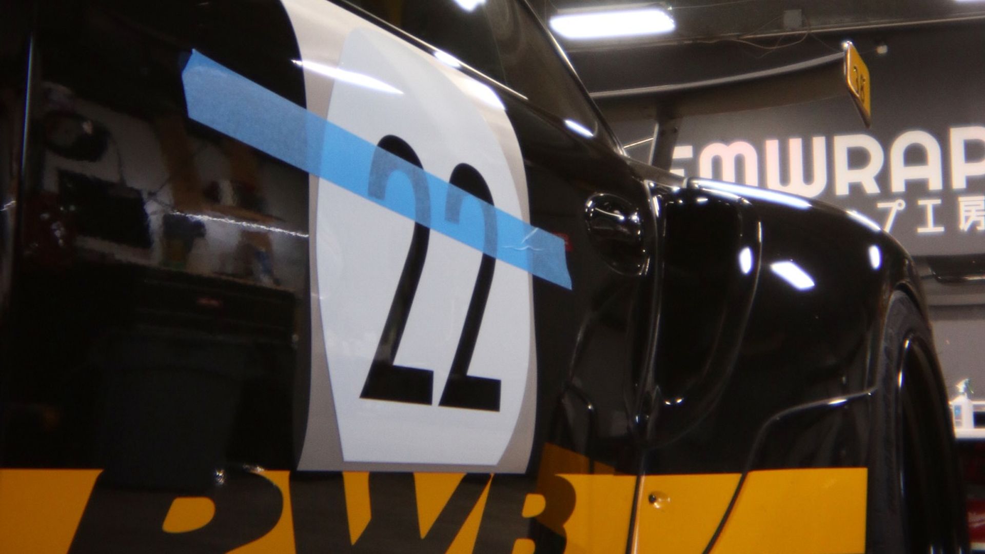 Black and yellow RWB Porsche 997 #22 with wide body kit inside EMWRAPS